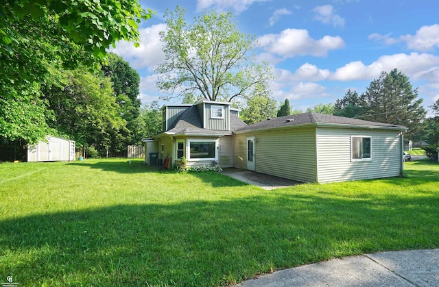 432 Eagle Pass St, Lapeer, MI 48446 - rear view of house with a yard and a patio