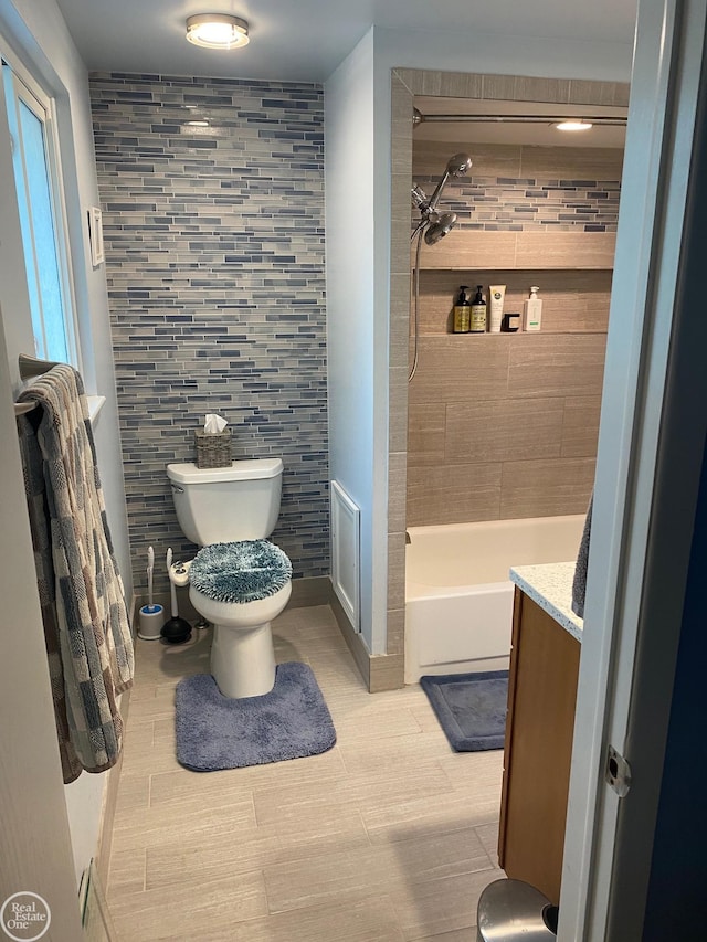 44854 Forest Trail Dr, Canton, MI 48187 - bathroom featuring toilet, vanity, tile walls, and bathing tub / shower combination