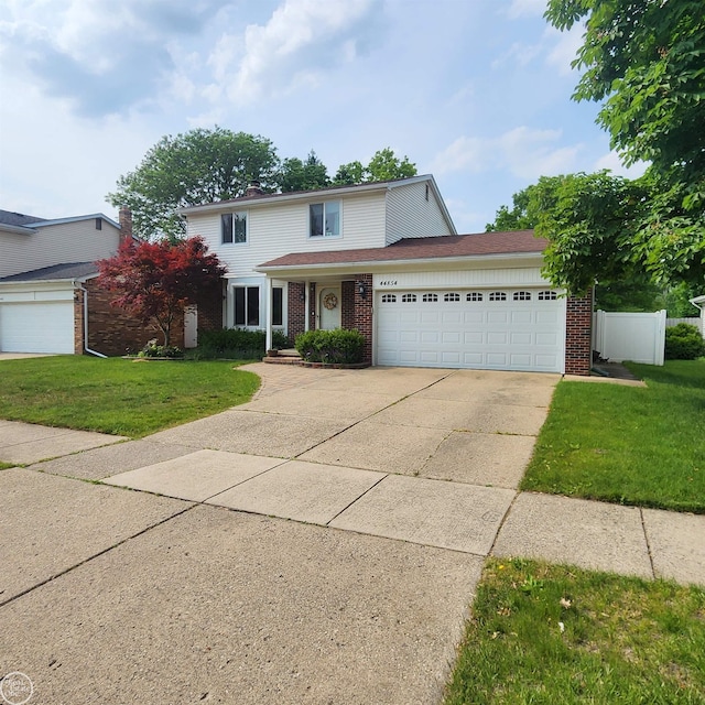 44854 Forest Trail Dr, Canton, MI 48187 - traditional-style house featuring brick siding, driveway, and an attached garage