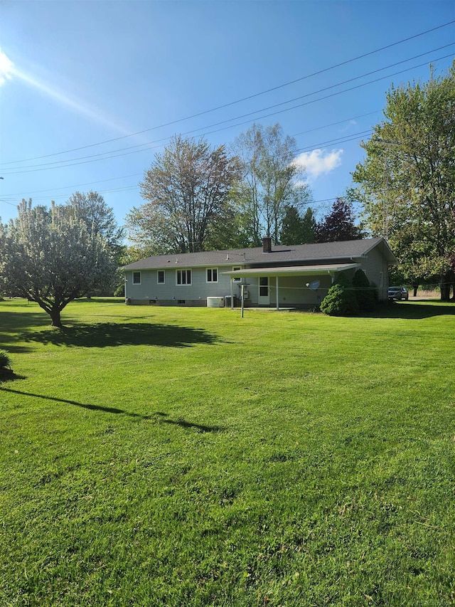 4590 Main St, Applegate, MI 48401 - rear view of house featuring a lawn and a chimney