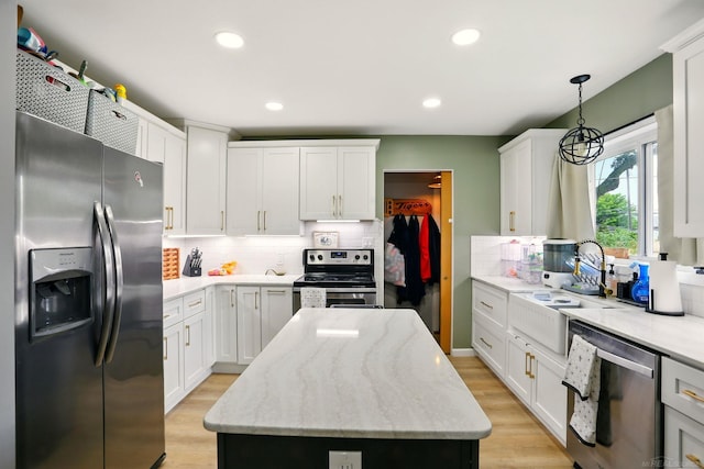 21629 Yale St, Saint Clair Shores, MI 48081 - kitchen featuring stainless steel appliances, decorative backsplash, a kitchen island, light wood-type flooring, and recessed lighting
