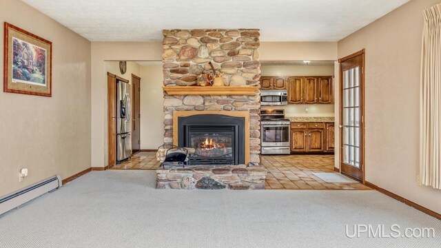 2119 S 21st Ave, Escanaba, MI 49829 - living room with a baseboard heating unit, a stone fireplace, light carpet, and baseboards