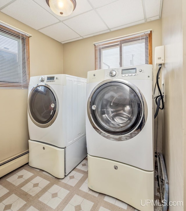 2119 S 21st Ave, Escanaba, MI 49829 - washroom featuring separate washer and dryer, a baseboard heating unit, and light flooring