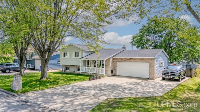 2119 S 21st Ave, Escanaba, MI 49829 - split level home featuring a garage, concrete driveway, brick siding, a front yard, and a chimney