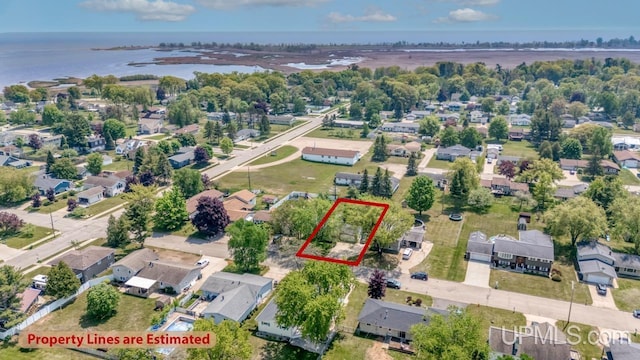 2119 S 21st Ave, Escanaba, MI 49829 - aerial perspective of suburban area featuring property parcel outlined and a large body of water