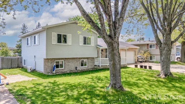 2119 S 21st Ave, Escanaba, MI 49829 - tri-level home with a garage and brick siding