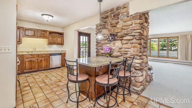 2119 S 21st Ave, Escanaba, MI 49829 - kitchen featuring dishwasher, plenty of natural light, brown cabinetry, a kitchen bar, and a textured ceiling