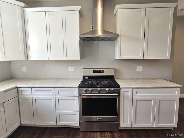 48050 Harma Rd, Atlantic Mine, MI 49905 - kitchen featuring stainless steel gas stove, wall chimney exhaust hood, white cabinetry, and dark wood-style flooring