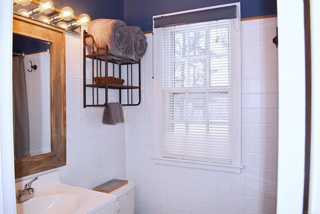 110 W Francis St, Ironwood, MI 49938 - bathroom with toilet, vanity, and tile walls