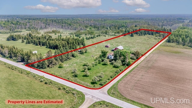 8102 W.5 Rd, Rapid River, MI 49878 - aerial view of property and surrounding area featuring a forest and property parcel outlined