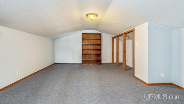 8102 W.5 Rd, Rapid River, MI 49878 - additional living space featuring vaulted ceiling, carpet floors, and baseboards