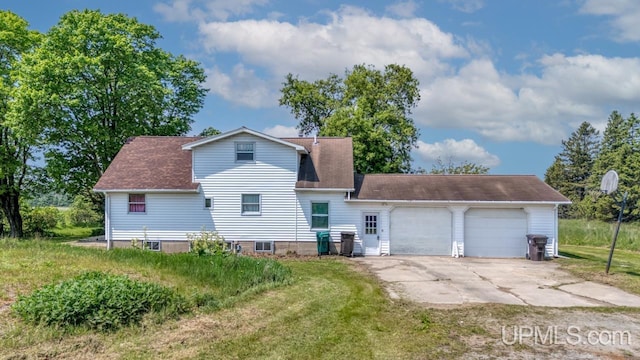 8102 W.5 Rd, Rapid River, MI 49878 - rear view of house featuring a garage, driveway, a lawn, and a shingled roof