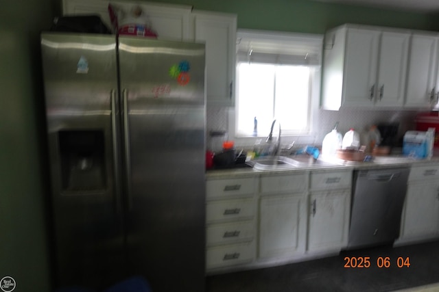 1321 Cornell Rd, Muskegon, MI 49441 - kitchen featuring appliances with stainless steel finishes, a sink, light countertops, and white cabinetry