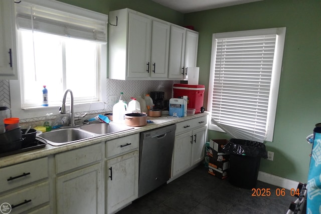 1321 Cornell Rd, Muskegon, MI 49441 - kitchen featuring dishwasher, a sink, backsplash, and dark tile patterned floors
