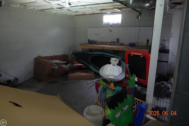 1321 Cornell Rd, Muskegon, MI 49441 - basement featuring a workshop area and concrete block wall