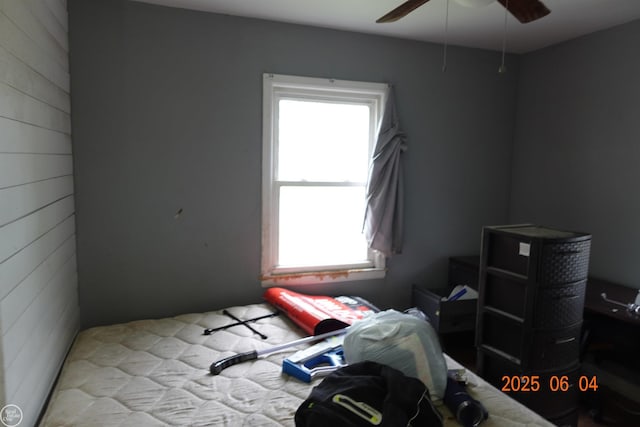 1321 Cornell Rd, Muskegon, MI 49441 - bedroom with wood walls and ceiling fan