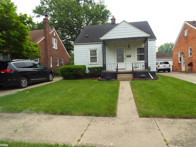 21824 Colony St, Saint Clair Shores, MI 48080 - bungalow-style home featuring a front yard, covered porch, and a chimney
