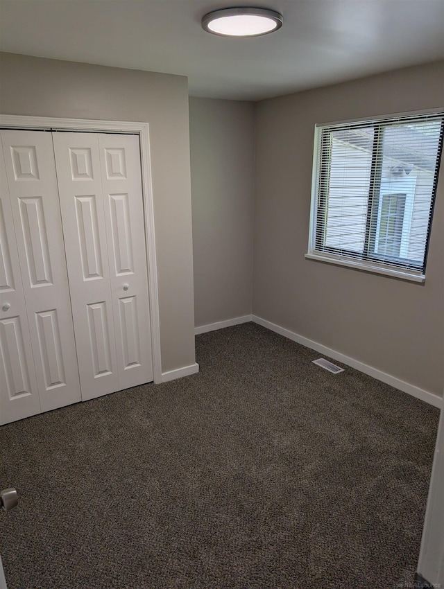 60606 Avendt Dr, New Haven, MI 48048 - unfurnished bedroom with dark carpet, baseboards, and a closet