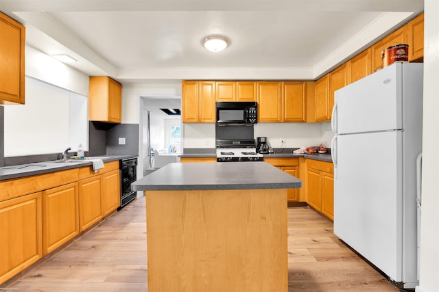 28316 Little Mack Ave, Saint Clair Shores, MI 48081 - kitchen featuring black appliances, dark countertops, light wood-style floors, a kitchen island, and a sink