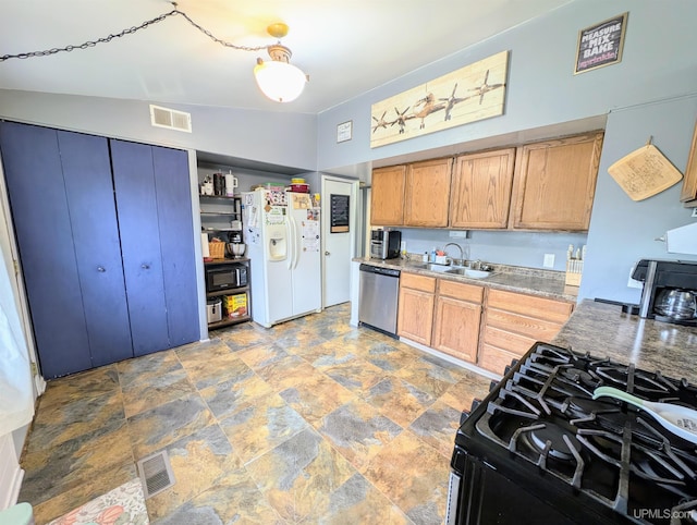 104 Provider St, Gwinn, MI 49841 - kitchen with stainless steel dishwasher, white refrigerator with ice dispenser, gas stove, a sink, and light stone finish flooring