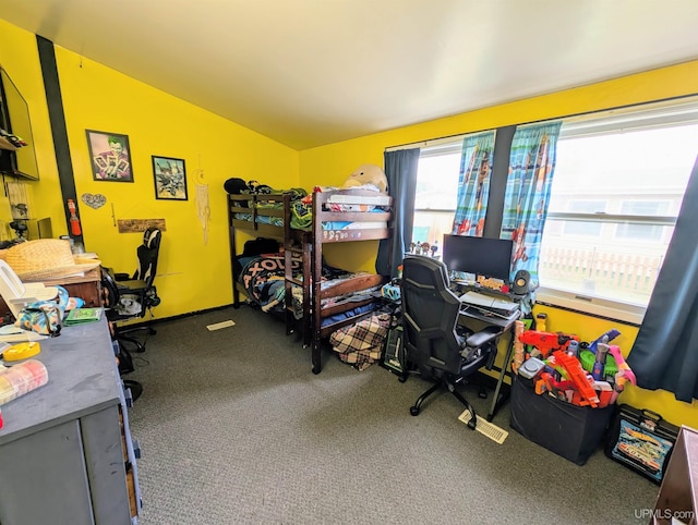 104 Provider St, Gwinn, MI 49841 - carpeted bedroom featuring vaulted ceiling, multiple windows, and a desk