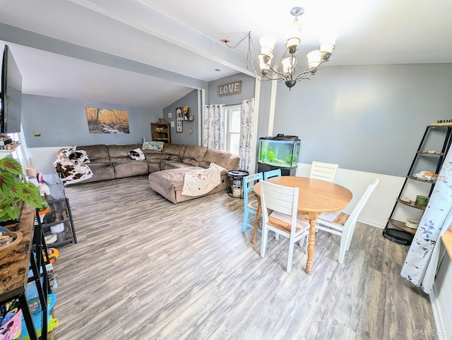 104 Provider St, Gwinn, MI 49841 - dining space featuring wood finished floors, a chandelier, and lofted ceiling
