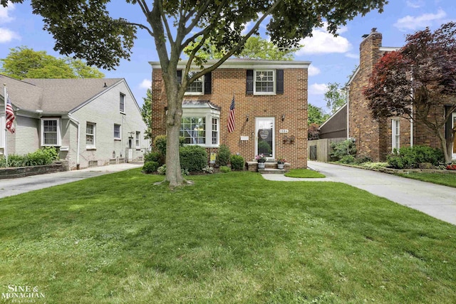 1984 Lancaster St, Grosse Pointe Woods, MI 48236 - view of front facade featuring a front yard and brick siding