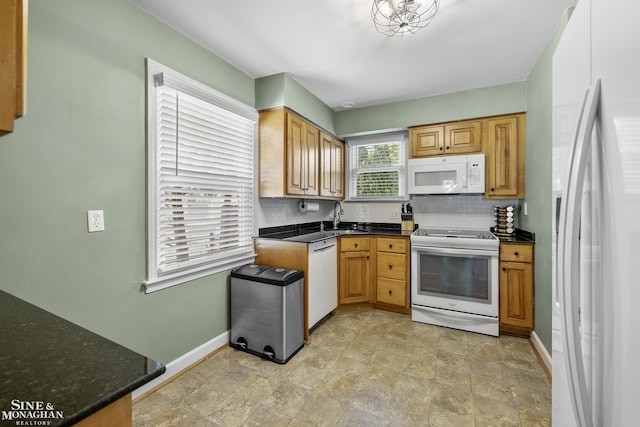 1984 Lancaster St, Grosse Pointe Woods, MI 48236 - kitchen featuring white appliances, a sink, decorative backsplash, and baseboards