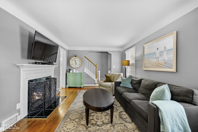 1984 Lancaster St, Grosse Pointe Woods, MI 48236 - living area featuring stairs, wood finished floors, and a tiled fireplace