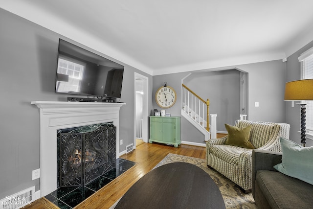 1984 Lancaster St, Grosse Pointe Woods, MI 48236 - living area featuring stairs, wood finished floors, a fireplace with flush hearth, and baseboards