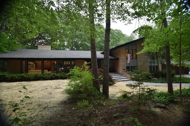 5400 Siebert St, Midland, MI 48640 - view of front facade with a chimney and brick siding