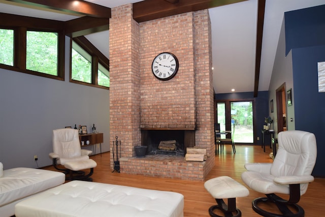 5400 Siebert St, Midland, MI 48640 - living room featuring high vaulted ceiling, beam ceiling, wood finished floors, and a brick fireplace