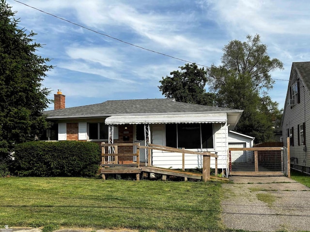 3109 Yale St, Flint, MI 48503 - view of front of house with a chimney, an outdoor structure, and a deck