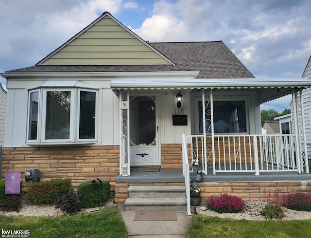 21758 Rausch Ave, Eastpointe, MI 48021 - view of front of home with a porch, roof with shingles, and stone siding