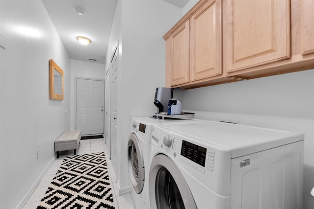 5555 Acorn Ln, Sterling Heights, MI 48314 - laundry area featuring cabinet space, light tile patterned floors, and washer and clothes dryer