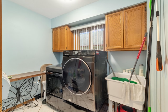52225 Bryan Michael Dr, Macomb, MI 48042 - laundry room with washer / clothes dryer, cabinet space, and light tile patterned floors