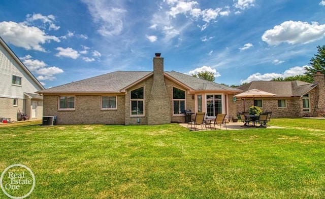 52225 Bryan Michael Dr, Macomb, MI 48042 - back of house with a chimney, a yard, a patio, and brick siding