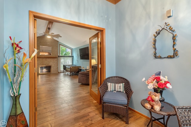 52225 Bryan Michael Dr, Macomb, MI 48042 - sitting room with wood finished floors, lofted ceiling, a fireplace, and ceiling fan