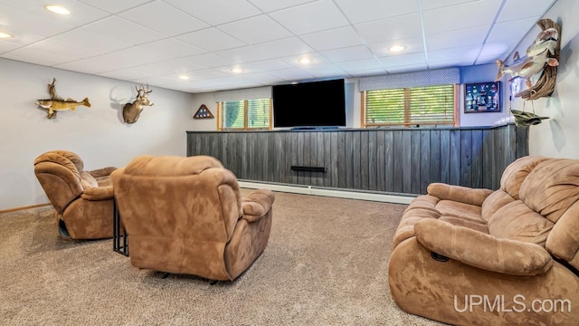 533 25th St, Gladstone, MI 49837 - carpeted home theater room featuring baseboard heating, a paneled ceiling, and a wainscoted wall