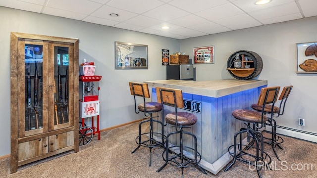 533 25th St, Gladstone, MI 49837 - indoor dry bar with carpet floors, a paneled ceiling, a baseboard heating unit, and freestanding refrigerator