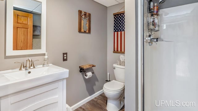533 25th St, Gladstone, MI 49837 - bathroom featuring a shower, vanity, and wood finished floors
