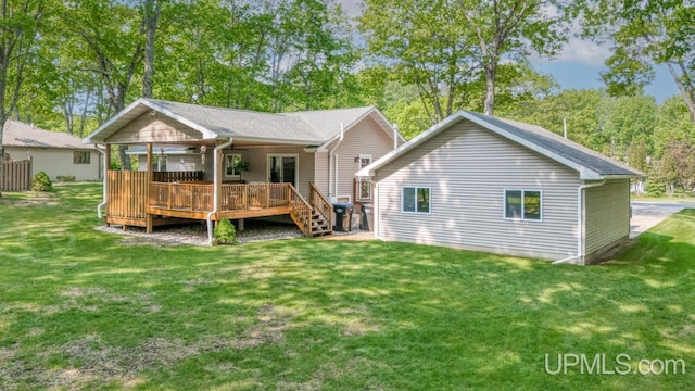 533 25th St, Gladstone, MI 49837 - back of house featuring a yard and a wooden deck