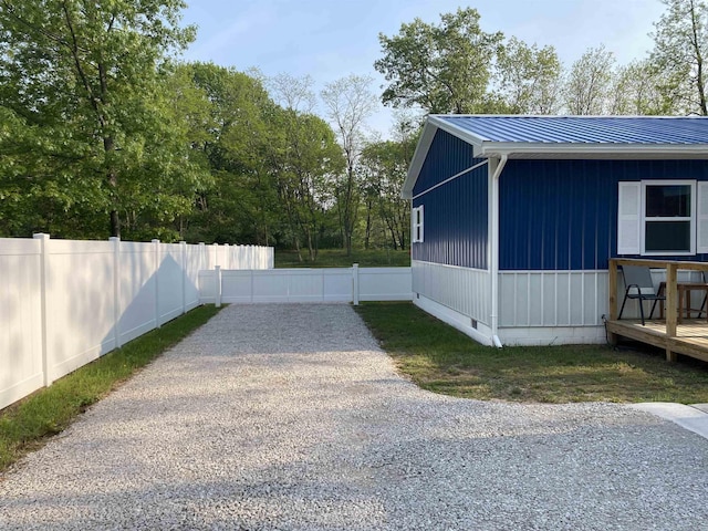 1335 28th St, Manistee, MI 49660 - view of property exterior with crawl space, gravel driveway, and a metal roof