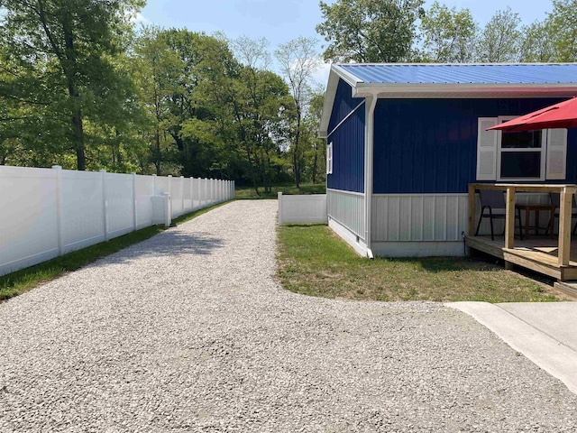 1335 28th St, Manistee, MI 49660 - view of home's exterior featuring a metal roof and gravel driveway