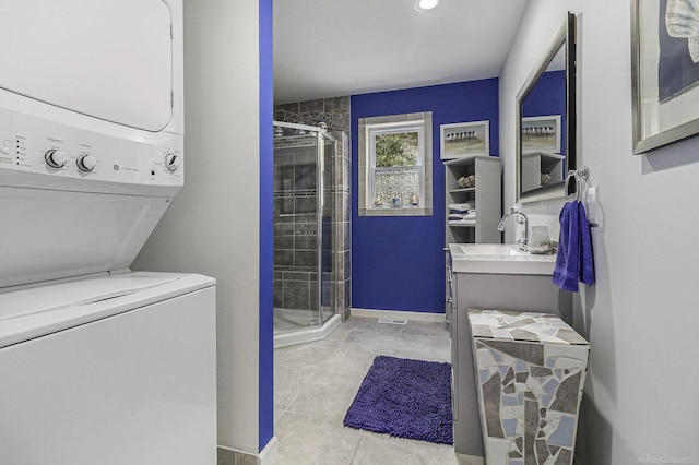 1335 28th St, Manistee, MI 49660 - laundry area featuring stacked washer / drying machine and light tile patterned floors