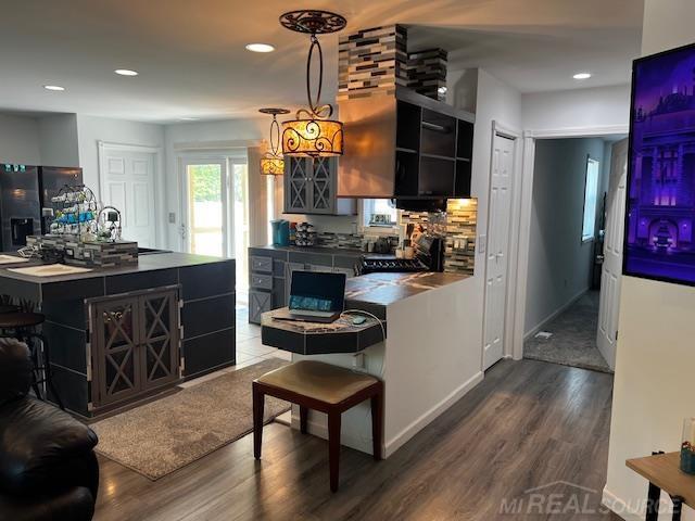 1335 28th St, Manistee, MI 49660 - kitchen featuring dark cabinetry, wood finished floors, black refrigerator with ice dispenser, dark countertops, and recessed lighting
