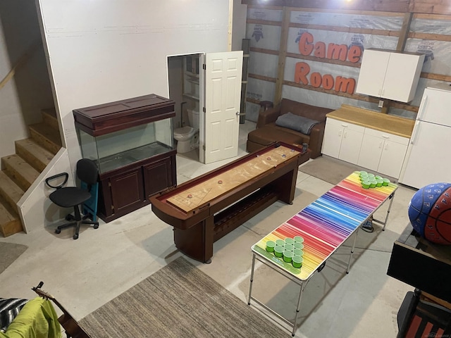 1335 28th St, Manistee, MI 49660 - below grade area with freestanding refrigerator and stairway