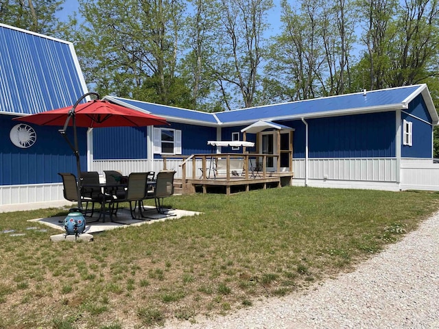 1335 28th St, Manistee, MI 49660 - back of house with a deck, a lawn, and a patio