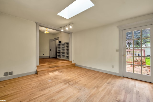 1200 Wells St, Ann Arbor, MI 48104 - empty room with a skylight, wood finished floors, and track lighting