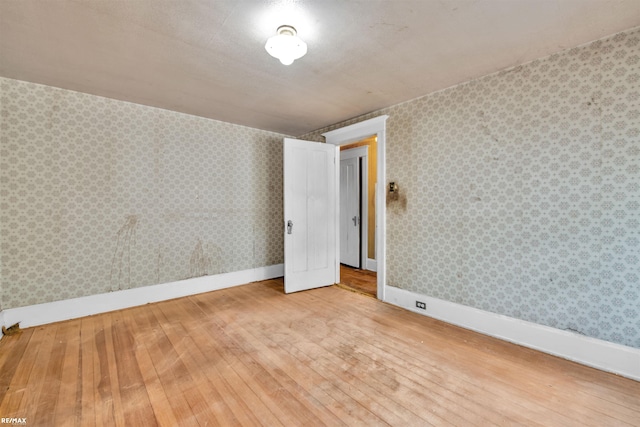 1200 Wells St, Ann Arbor, MI 48104 - empty room featuring wood-type flooring and baseboards